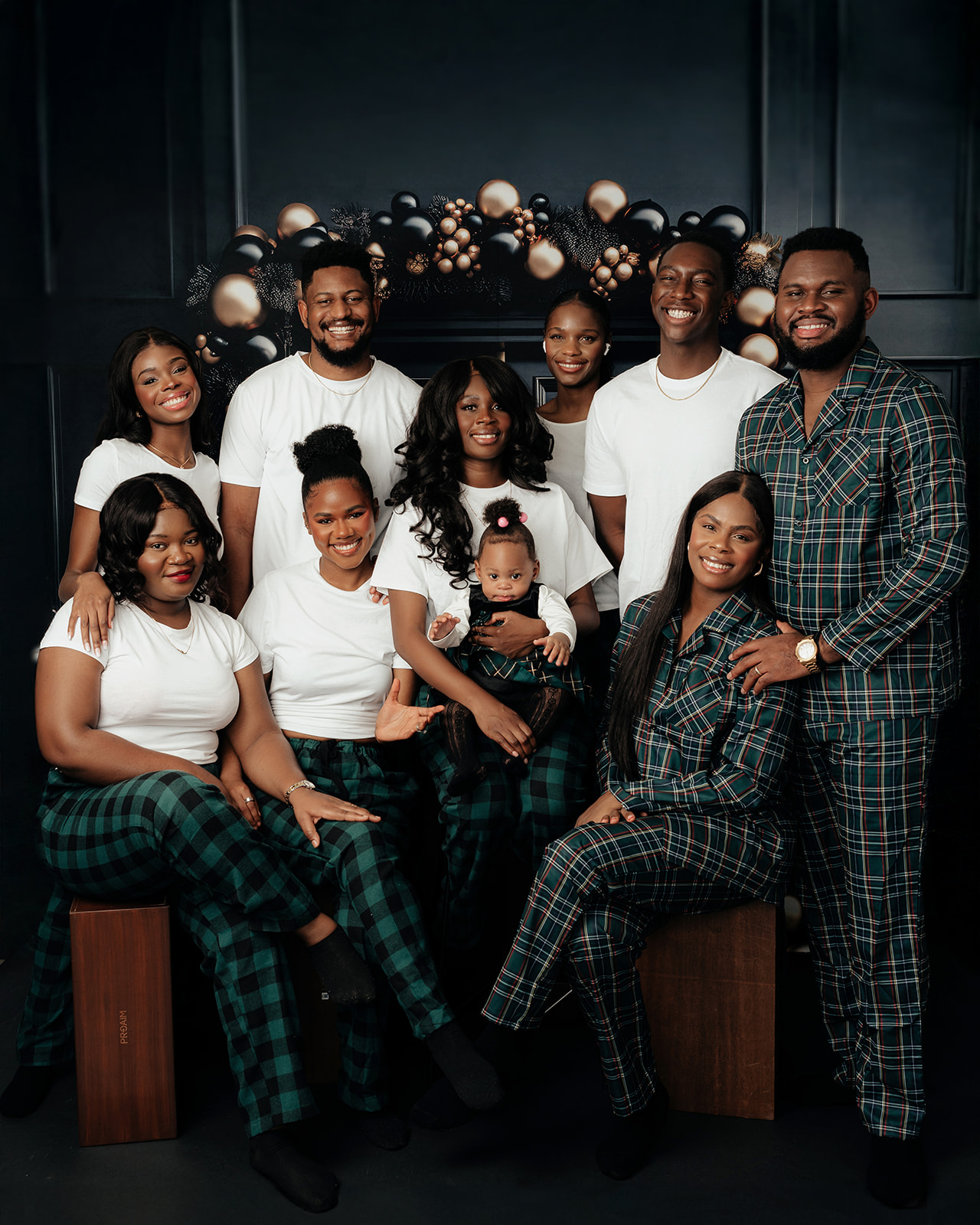 Family wearing matching Christmas pajamas during holiday session at a studio in Ontario